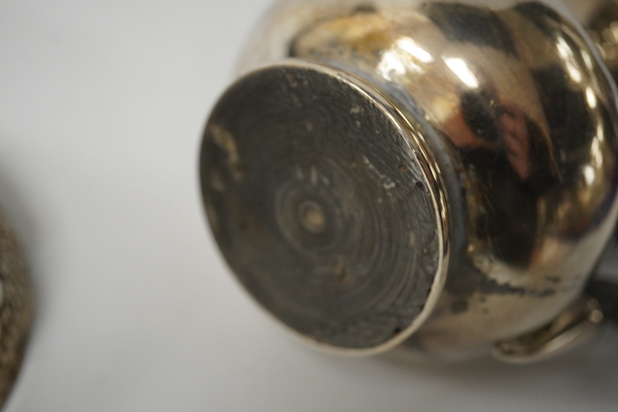 A small French white metal hot water pot, 13cm, a continental white metal bowl (a.f.) and a 19th century German white metal spoon. Condition - poor to fair